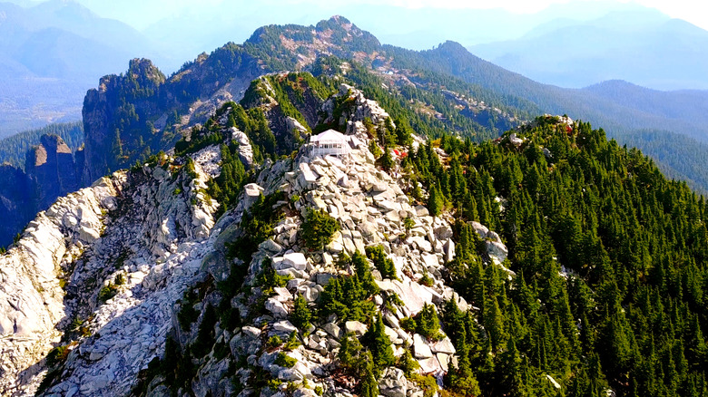 A mountain cabin on the top of a jagged outcrop