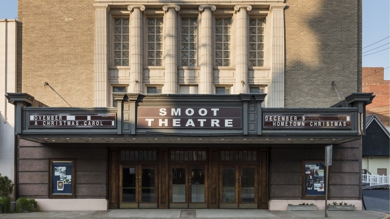 Gray brick building with columns above the Smoot Theatre