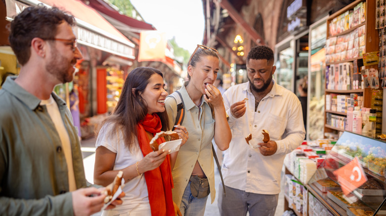 A group of people eating at a market
