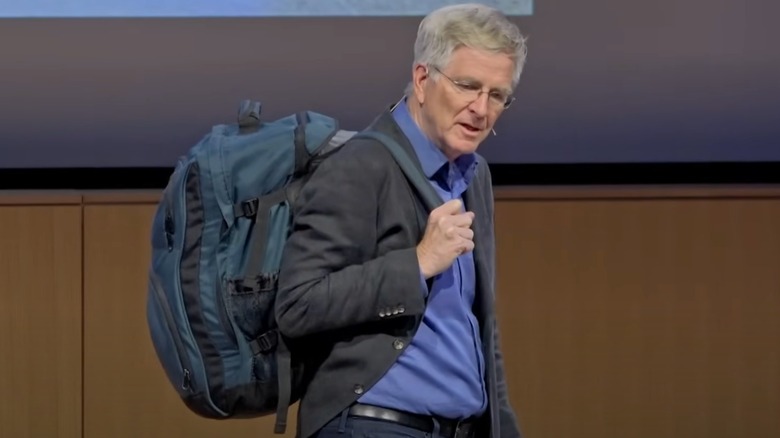 Rick Steves carrying a backpack