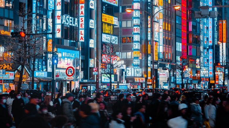 People walking across a busy Tokyo street