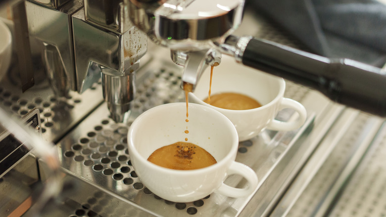 Espresso being poured into coffee cups