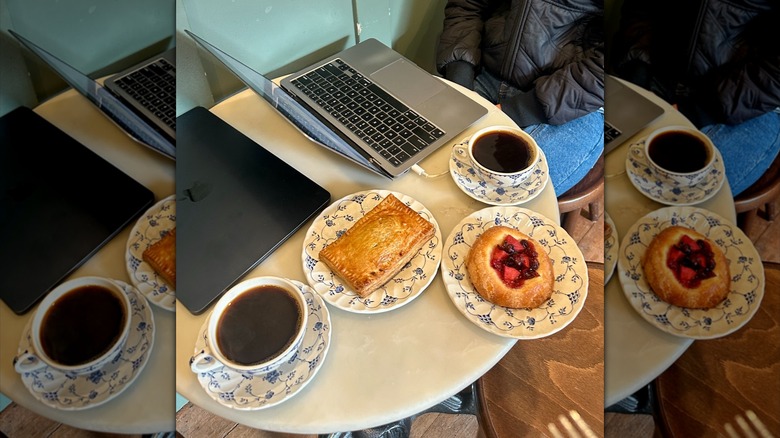 Coffees, pastries, and computers on a table