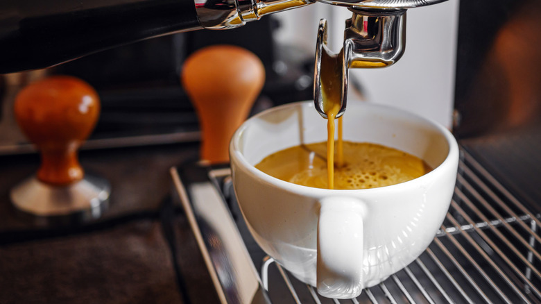 Close-up of espresso pouring into a cup