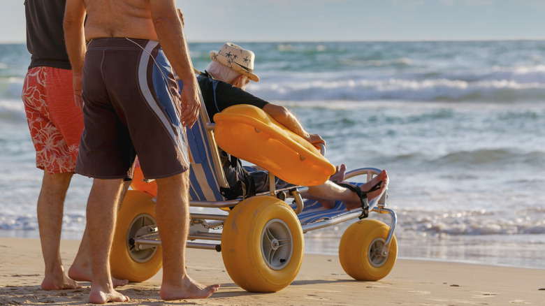 A person on a beach wheelchair at the beach