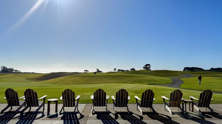 Adirondack chairs overlooking a golf course fairway at Bandon Dunes Golf Resort, Oregon