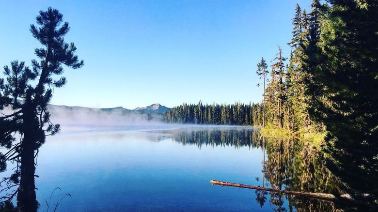 Summit Lake sapphire blue water mist green trees mountain