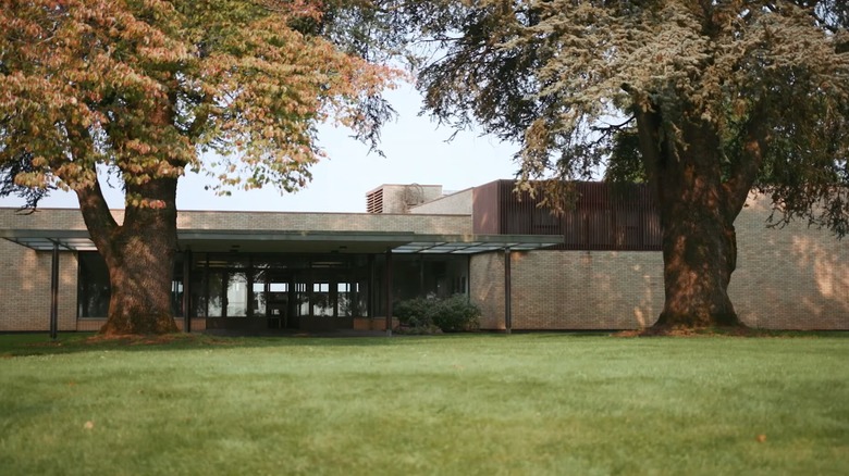 Exterior of Mount Angel Library in Oregon, framed by two big beautiful trees