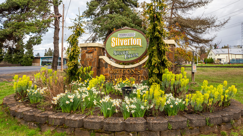 the Silverton, Oregon sign surrounded by flowers