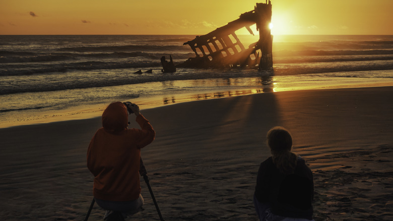 Visitors viewing the Peter Iredale wreck at Fort Stevens State Park