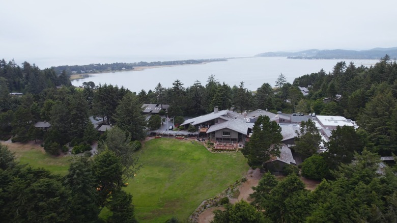 Salishan Coastal Lodge aerial drone view surrounded by forest and water.