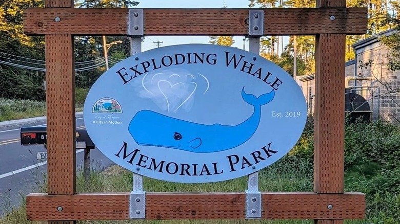 The Exploding Whale Memorial Park sign with a whale on it in Florence, Oregon
