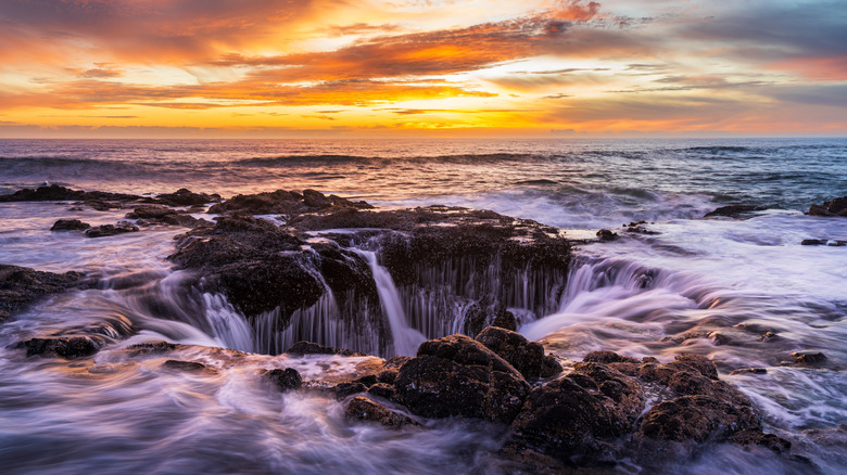 Thor's Well at sunset, where waves cascade into a natural sinkhole, Oregon