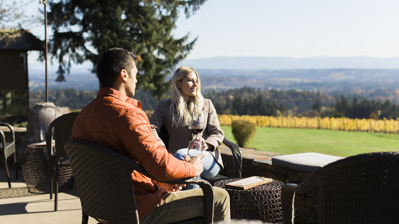 A couple sipping wine and mountain views