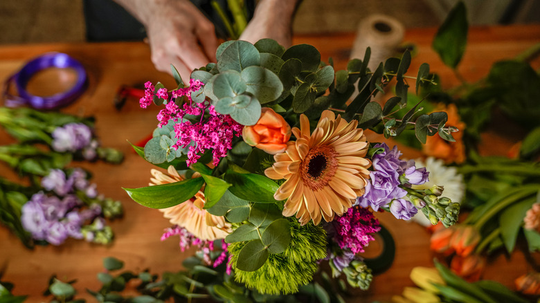 Someone creating a flower bouquet at a flower shop