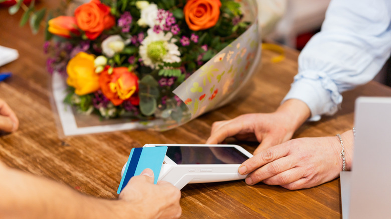 Customer paying for a flower bouquet