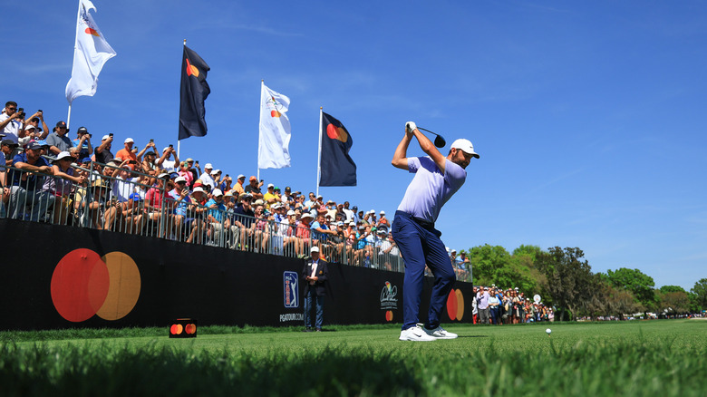 A golfer hitting a tee shot at ther Arnold Palmer Invitational at Arnold Palmer Bay Hill Golf Club