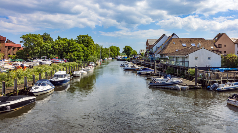 Looking down a river flowing through Christchurch with houses on either side