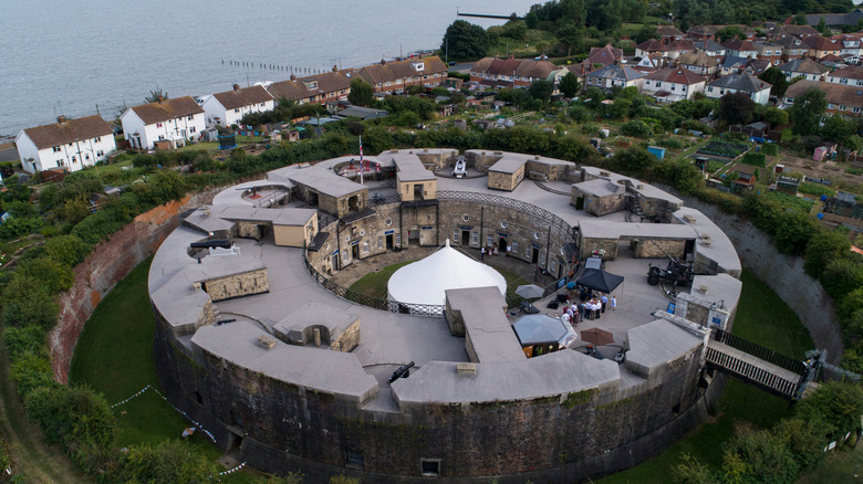 An aerial view of the circular Harwich Redoubt Fort bordered by trees and houses in Harwich, England