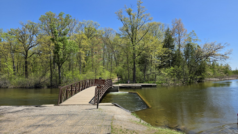 A bridge leading into the woods in the Proud Lake Recreation Area in Commerce Township, Michigan
