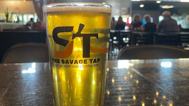 Close up of a craft beer at The Savage Tap in Savage, Minnesota with people blurred in the background.