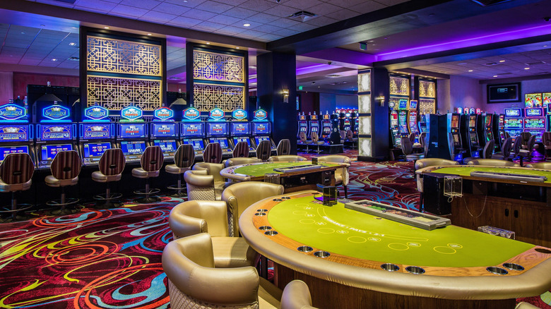 Inside of casino showing table game and slots