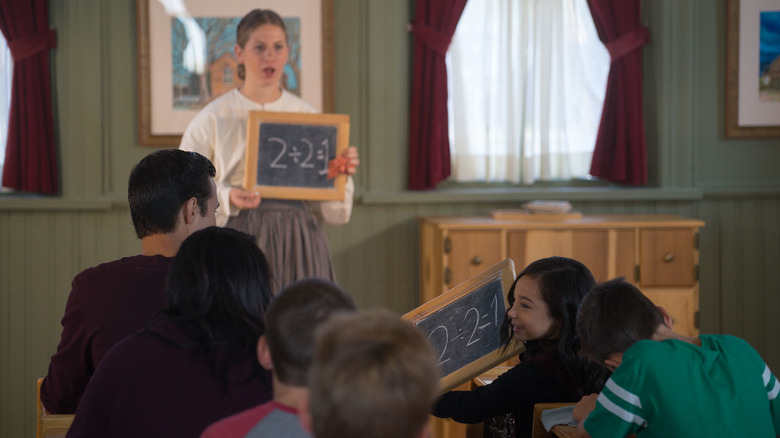 A teacher and students inside the schoolhouse at Camp Floyd State Park