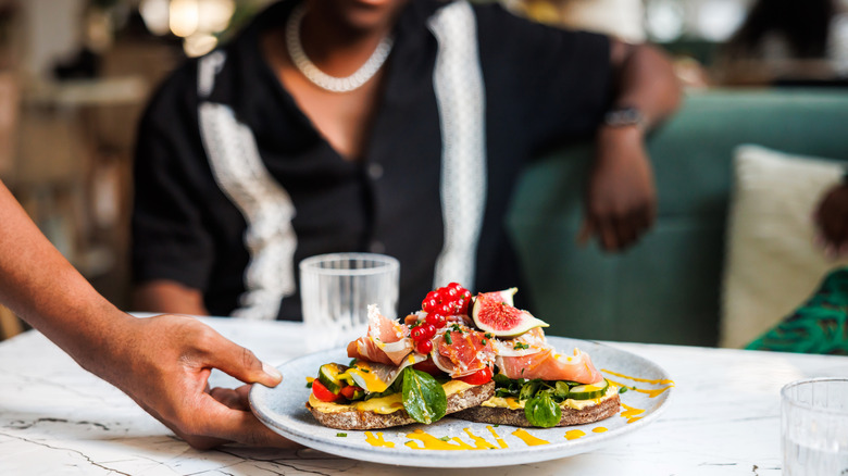 a patron is served lunch at a diner