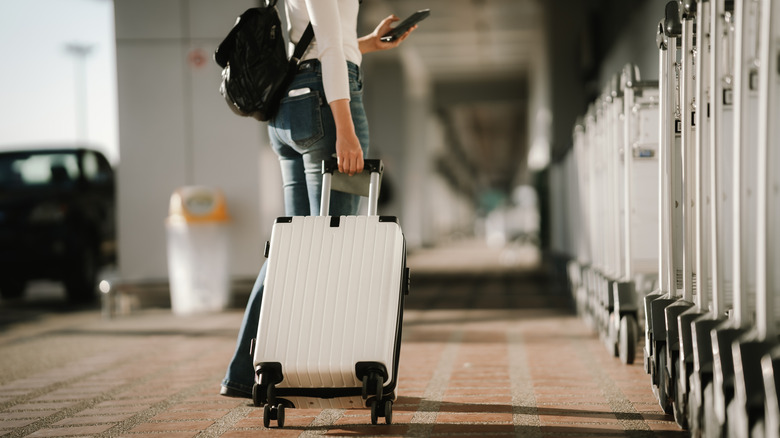 A young traveler with a carry-on suitcase at the airport
