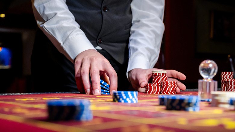 Guy pushing chips in a casino