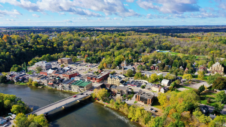 Aerial shot of Paris, Ontario in early autumn, with bridge over the river in front of the historic town