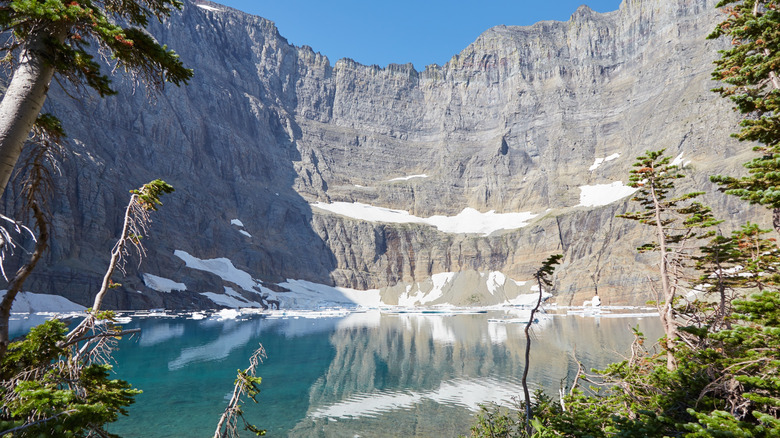 Alpine peaks, snow, and water of Iceberg Lake in Many Glacier area, a hike from Many Glacier Campground