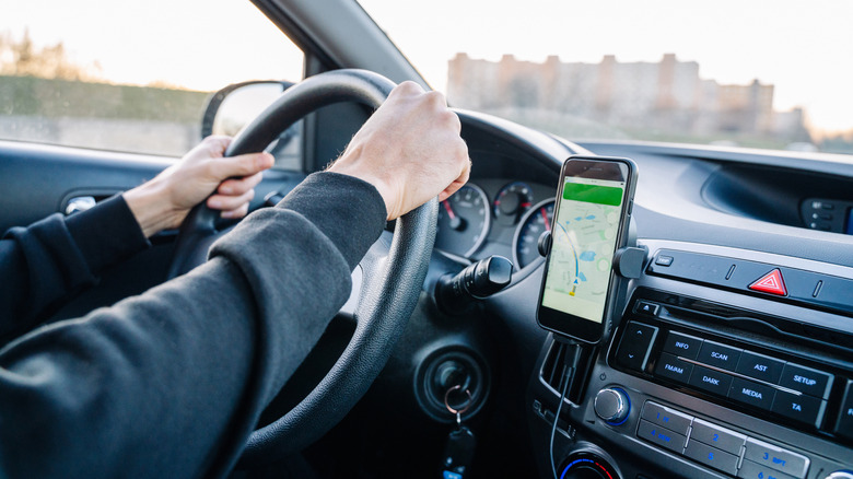 A driver uses a GPS system on his phone