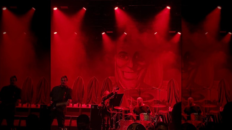 A band plays under red lights at the Archer Music Hall