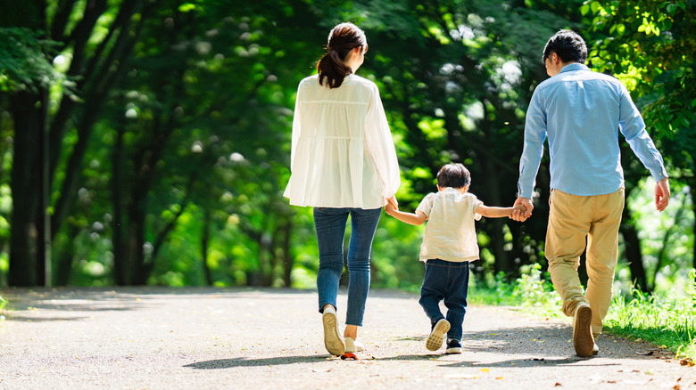 Family walking in a verdant park