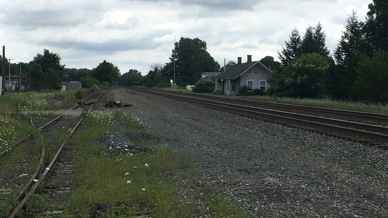 A building near a railroad track in Lake City, Pennsylvania
