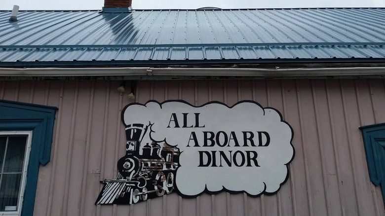 A sign reading All Aboard Dinor