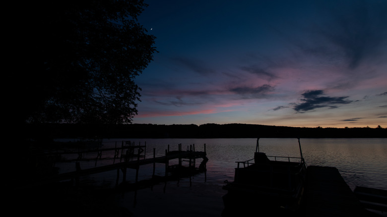 Canadohta Lake shore with boats at dusk