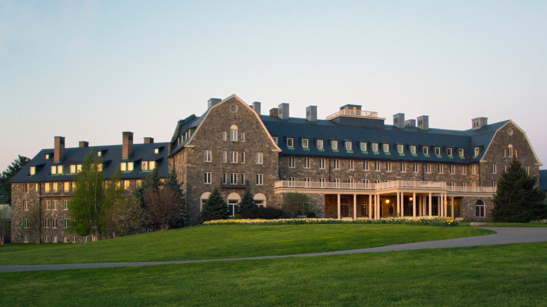 An exterior shot of the luxury Skytop Lodge in the Poconos, a multi-story brick building with white columns