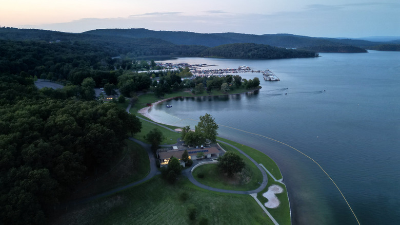 An aerial view of Raystown Lake with a marina and buildings, boats, and forests