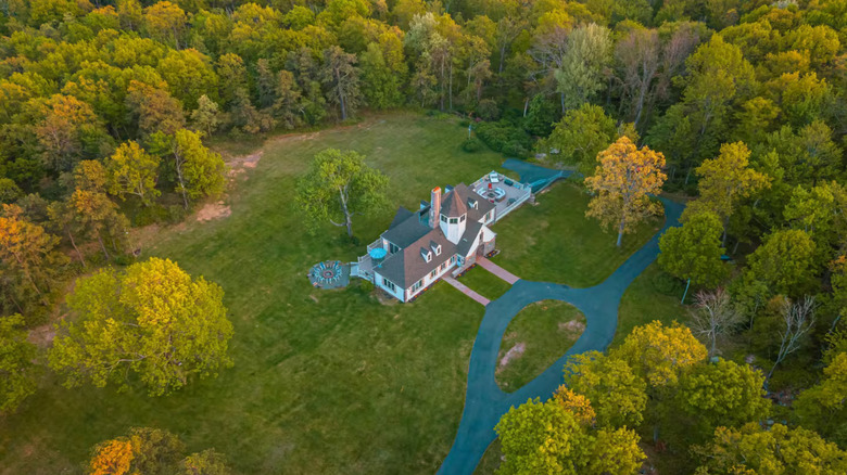 Aerial view of the Majestic Secluded Castle in Mount Poconos, Pennsylvania, pictured here during the fall surrounded by vibrant trees