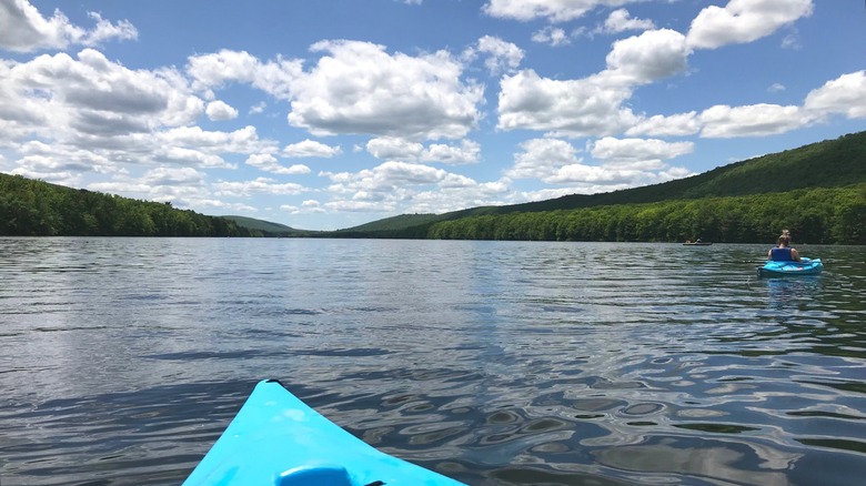 Kayakers paddling on the calm water on Mauch Chunk Lake near Jim Thorpe, PA.