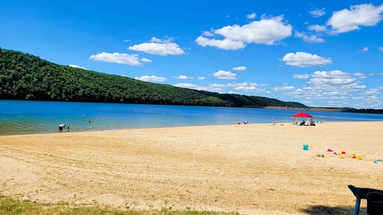 A pretty lakeside beach surrounded by rolling hills at Beltzville State Park in Pennsylvania