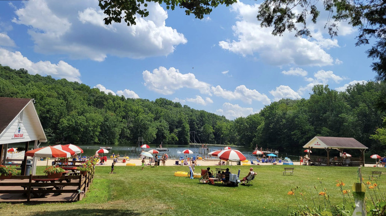The Mount Gretna Lake Beach during the summertime with a snack bar and colorful umbrellas