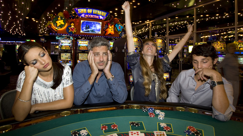 Bored casino-goers playing blackjack