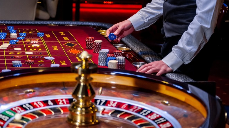 Close up of a croupier standing by the roulette table