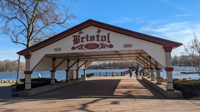 An outdoor shelter with "Bristol" on the side, next to a river