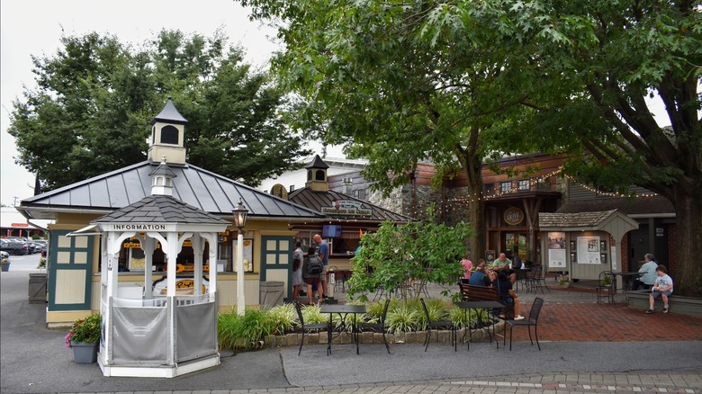 A cobblestone square surrounded by rustic buildings and trees at Kitchen Kettle Village.