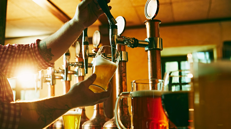 Bartender pouring craft beer from a tap