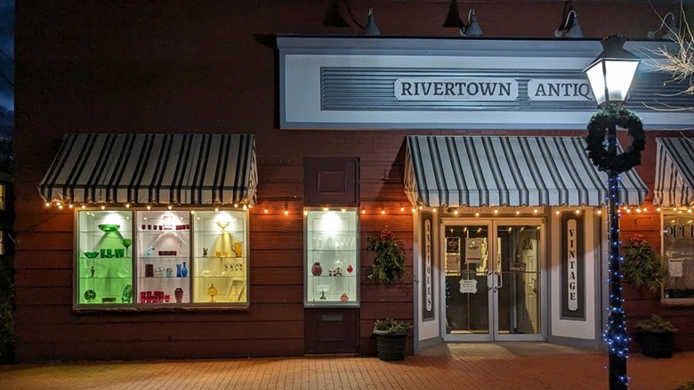 Brick storefront of Rivertown Antiques in Ambridge, Pennsylvania, with a lightpole decorated for Christmas in the foreground